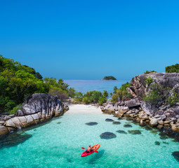 Aerial drone view of in kayak in crystal clear lagoon sea water during summer day near Koh Lipe...