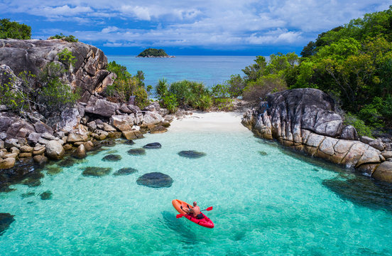 Aerial drone view of in kayak in crystal clear lagoon sea water during summer day near Koh Lipe island in Thailand. Travel tropical island holiday concept