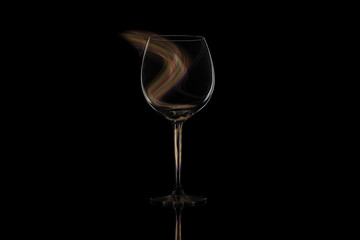 Wine glass on a black isolated background with light pattern