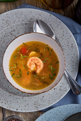 A set of healthy food in plates. Set of food in a cafe - soup and salad on a served table. On a wooden background. Copy space.