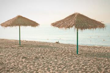 Umbrella of reeds on the beach. Summer mood. Best beach vibes