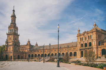 Fototapeta na wymiar View of the Plaza de España in Seville without people with warm colors and analog tones