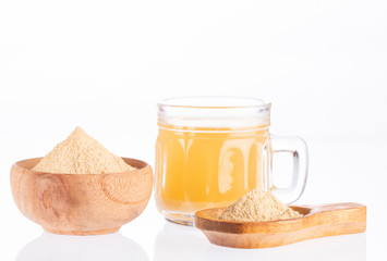 Maca root health drink in a glass with powdered - Lepidium meyenii. White background