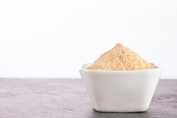 Organic maca powder - Lepidium meyenii. White background