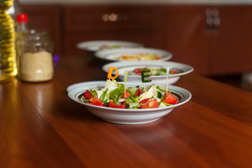 Several salads with vegetables and greens. Healthy food concept. Mixed vegetables