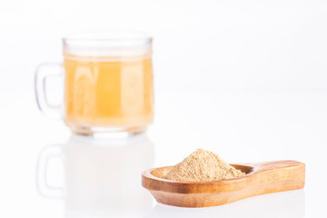 Maca root health drink in a glass with powdered - Lepidium meyenii. White background