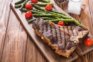 Grilled T-bone steak with asparagus and cherry tomatoes