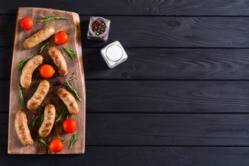 Fototapeta na wymiar Grilled sausages with tomatoes , pepper and rosemary