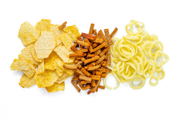 Assortment of Unhealthy Snacks: chips, onion rings, crackers top view, flat lay. Unhealthy eating concept.