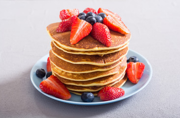 Tasty pancakes with blueberry and strawberry