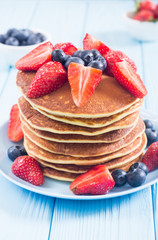 Tasty pancakes with blueberry and strawberry