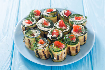 Zucchini rolls with cream cheese , tomatoes and dill