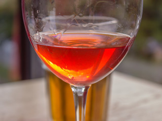 Friendly meeting with a glass of wine and a glass of beer in the city cafe.