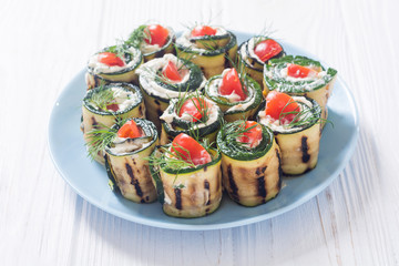 Zucchini rolls with cream cheese , tomatoes and dill