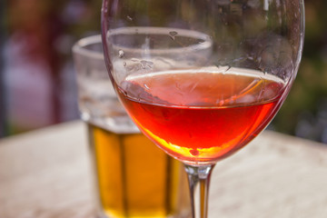 Friendly meeting with a glass of wine and a glass of beer in the city cafe.