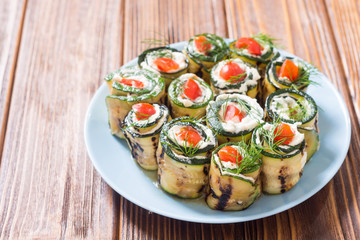 Zucchini rolls with cream cheese , tomatoes and dill