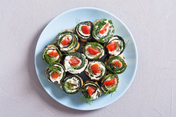 Zucchini rolls with cream cheese , tomatoes and dill