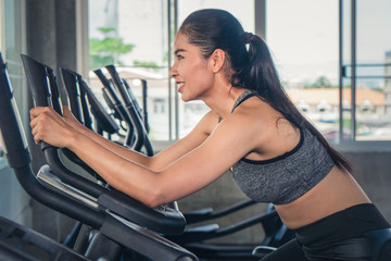 female having exercise with bicycle in gym