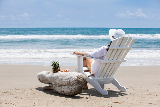 Woman relaxing at a paradisiac tropical beach in a beautiful sunny day