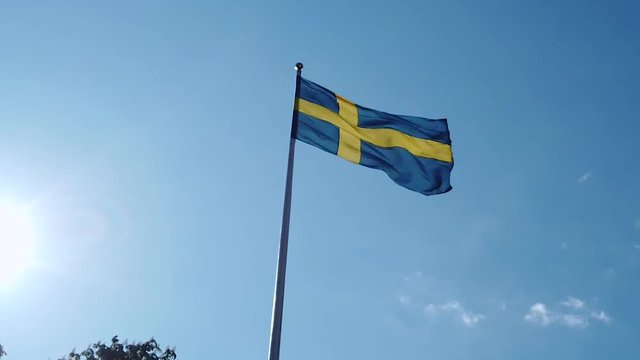 Flag of sweden swirling in the wind. Swedish flag with blue and yellow colors flutter. FullHD 120fps Presented as 30fps.