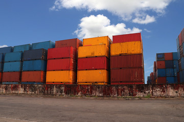 Fototapeta premium Shipping Containers placed as layered in the storage facility on blue sky background.