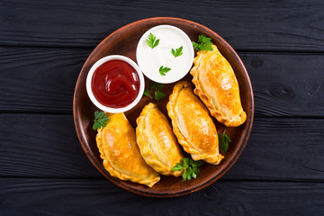 Latin American baked beef empanadas with sauce