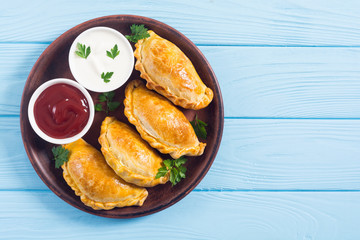 Latin American baked beef empanadas with sauce