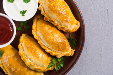 Latin American baked beef empanadas with sauce