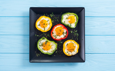 Yellow , red and green pepper with fried eggs