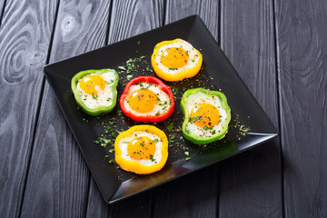 Yellow , red and green pepper with fried eggs