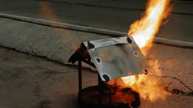 Practises how to use a fire extinguisher , using fire extinguisher fighting 
