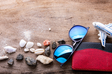 Travel concept on wooden table with film camera.Top view of beach summer accessories with copy space, Thailand passport, clothes.