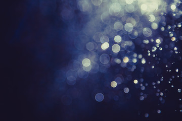 bokeh of water fly and lights on black background,