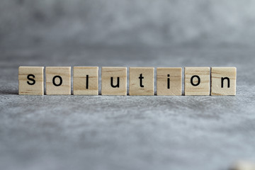 Solution word written on wood cube