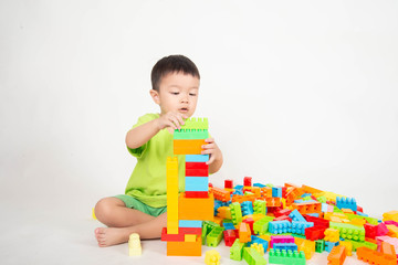 Little boy toddler playing plastic brick block colorful with happy