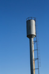 water tower on blue sky background