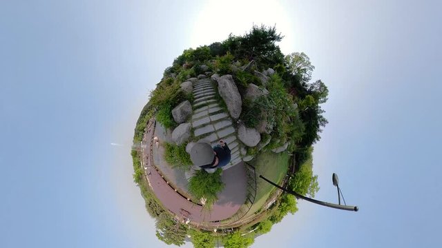 Ansan, South Korea - 12 June 2019 Artificial waterfall and Fountains in Ansan Nojeokbong Park edited by Gopro Fusion 360 Little Planet view.