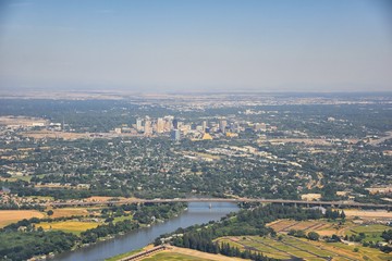 Sacramento downtown aerial from airplane, including view of rural surrounding farming and agricultural fields, river and landscape. California, United States.