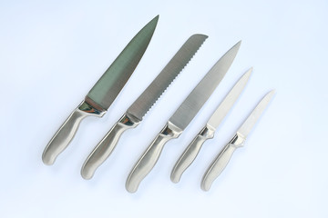 Obraz premium Set of professional kitchen knives on a white, top view