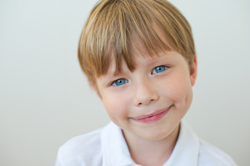 Photo of adorable young happy boy looking at camera