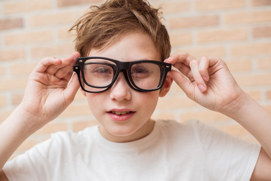 Handsome teen boy wears glasses. Poor vision and medicine concept