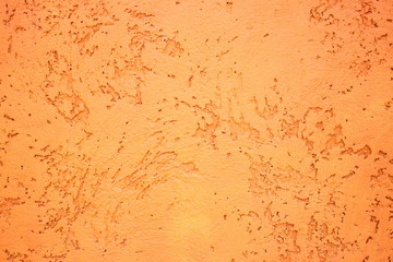 Raw orange and brown cement wall with the many scratched pattern as abstract textured and background
