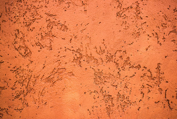 Raw orange and brown cement wall with the many scratched pattern as abstract textured and background