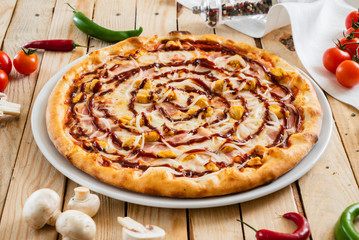 tasty pizza on the wooden background