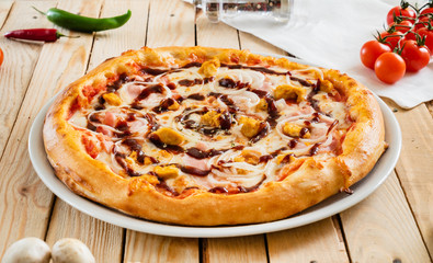 tasty pizza on the wooden background