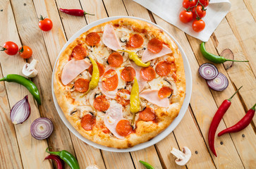 tasty pizza on the wooden background