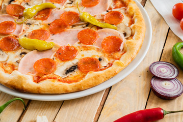tasty pizza on the wooden background