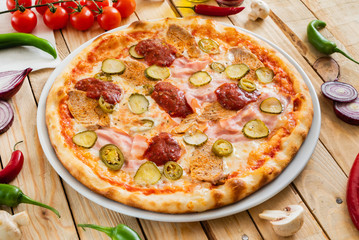 tasty pizza on the wooden background