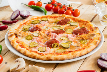 tasty pizza on the wooden background