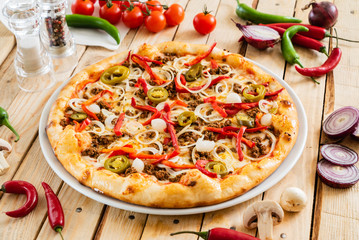 tasty pizza on the wooden background